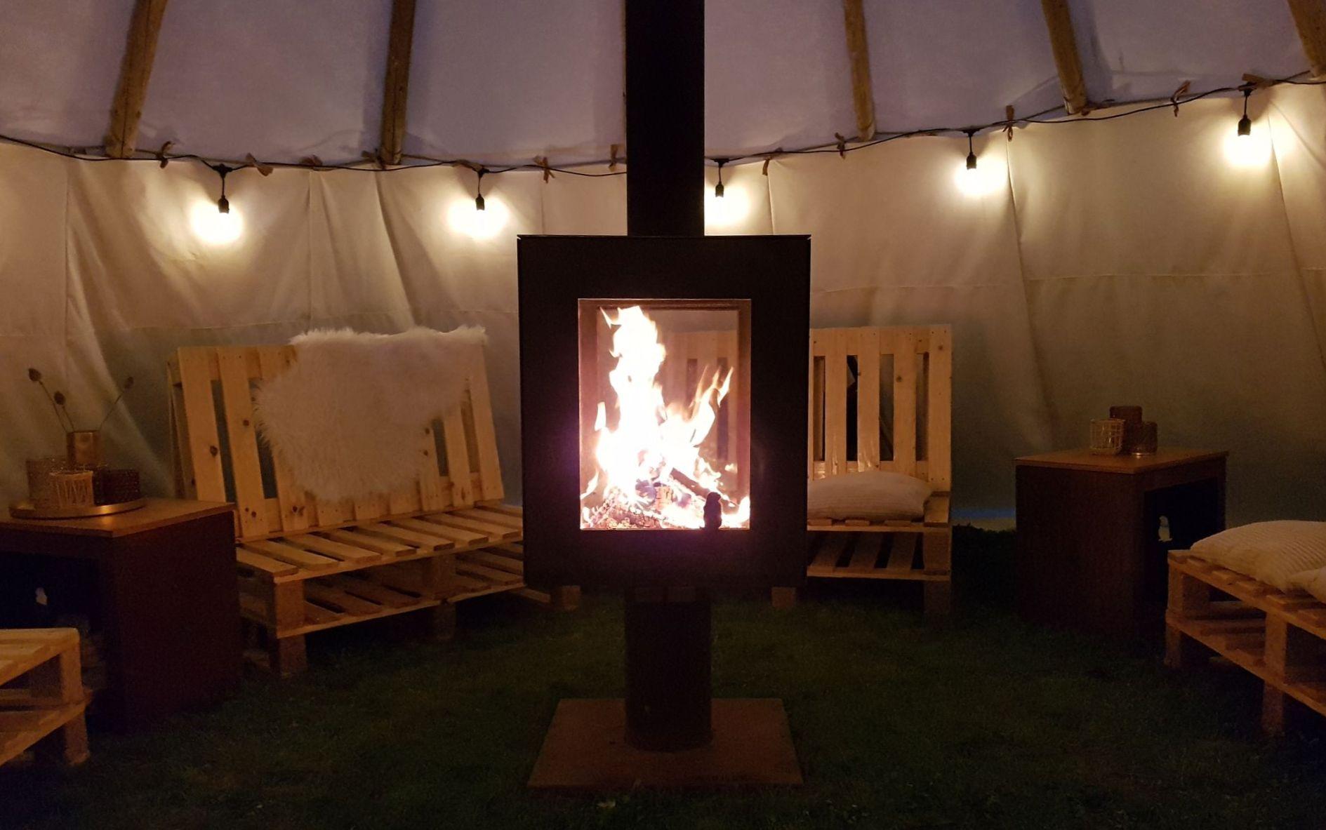 Woodchuck S terrace stove with wood fire in Indian tent