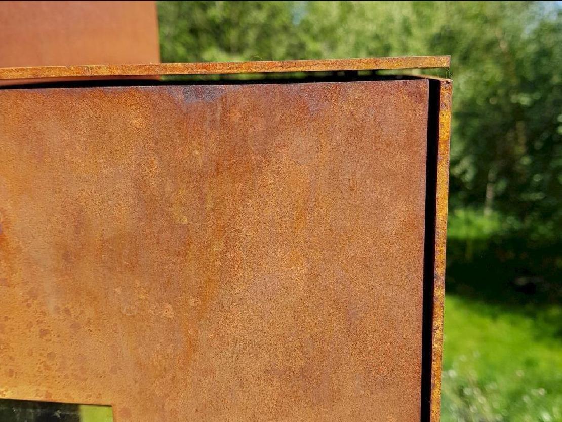 Detail of a Corten steel corner of the Woodchuck stove